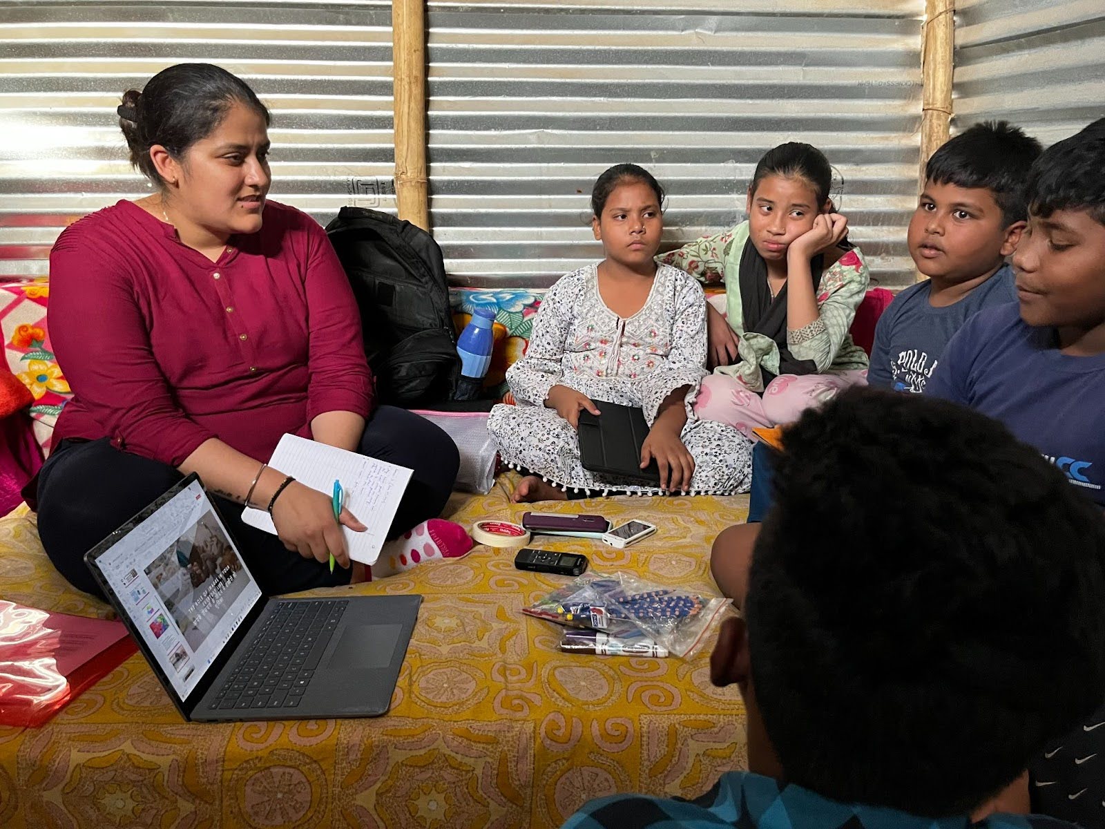 CLICK researcher gathered with a group of children