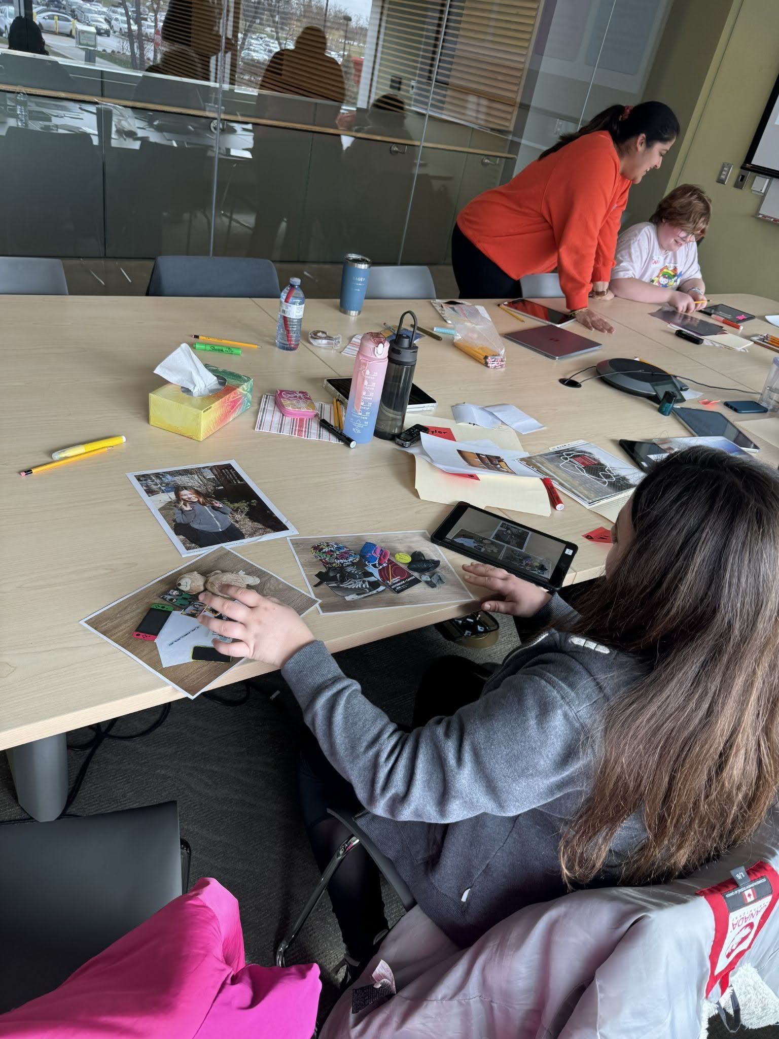 Students and an educator working on a photo project together.