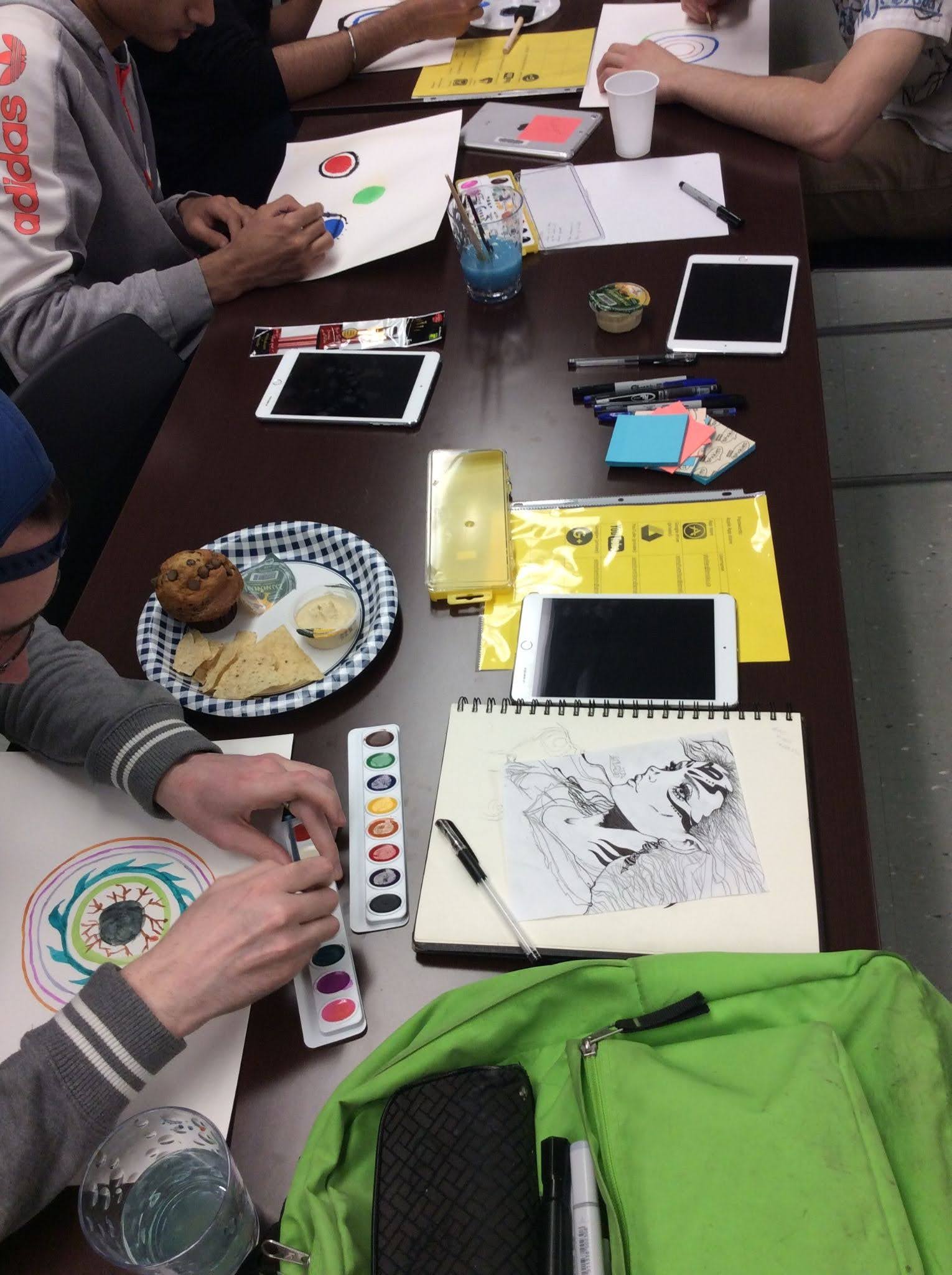 Group of children working on art projects at a table.