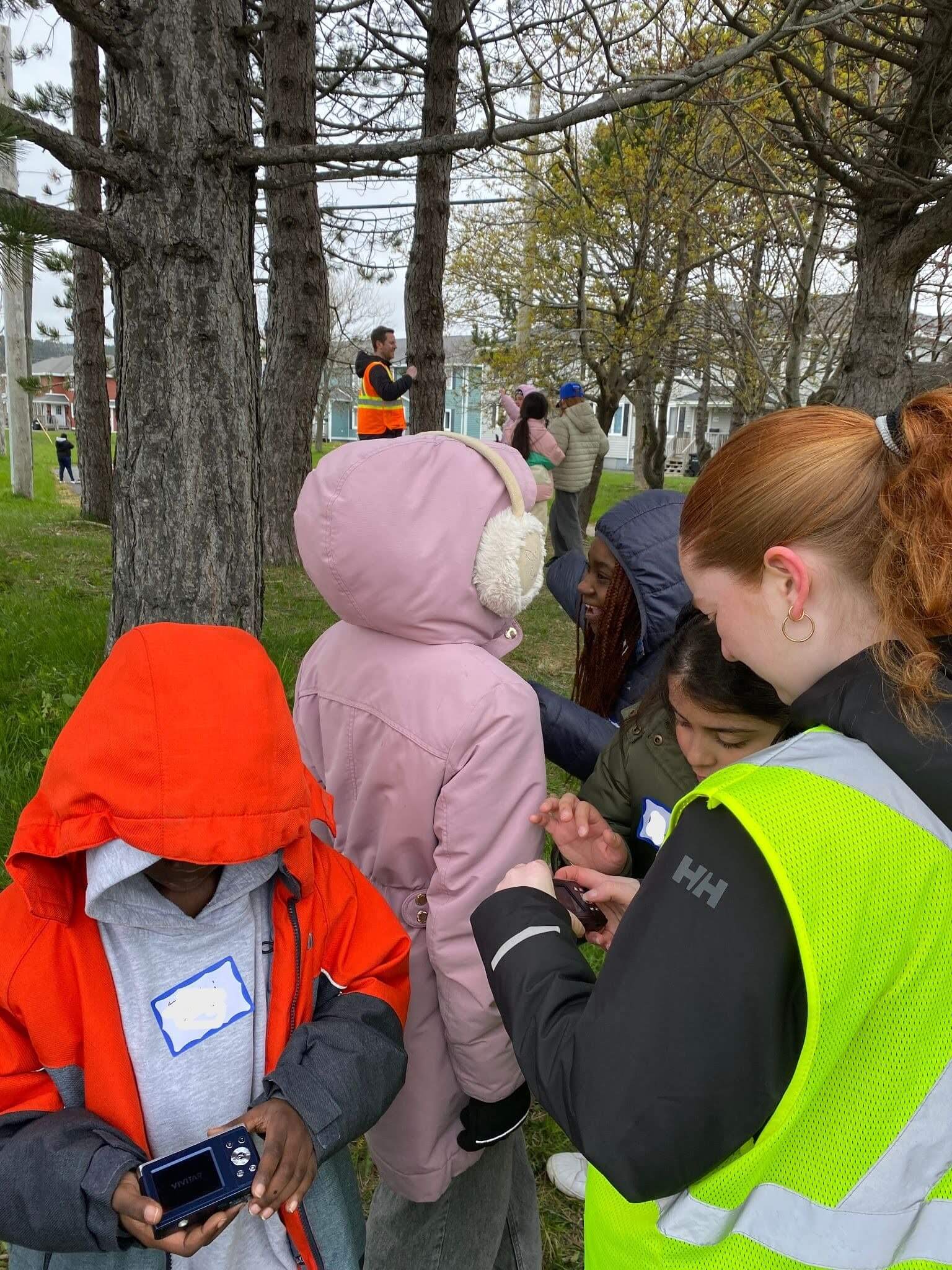 Group of children and adults exploring outside